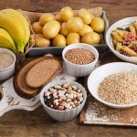 Foods high in carbohydrate on wooden background. Top view