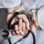 Female Doctor or Nurse In Handcuffs and Lab Coat Holding Stethoscope.