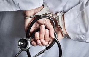 Female Doctor or Nurse In Handcuffs and Lab Coat Holding Stethoscope.