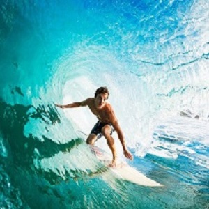 Surfer on Blue Ocean Wave in the Tube Getting Barreled