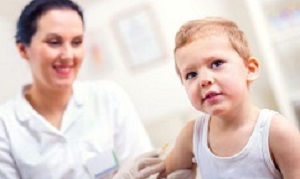 Female pediatrician makes vaccination to small boy