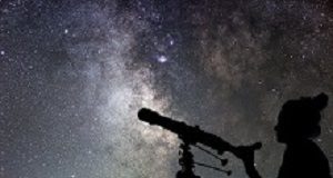 'Gender paradox' of more women taking STEM degrees in unequal countries Woman and night sky. Watching the stars Woman with telescope.