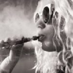 Black and white picture of woman smoking e-cigarette
