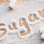 Inscription sugar made into pile of white granulated sugar