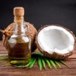 Coconut and coconut oil on wooden table