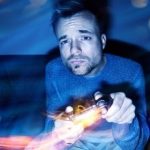 Man playing video games at night