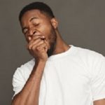 Black man yawning on grey background, studio shot, copy space