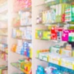 Medicines on pharmacy store shelves blurred background