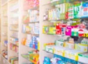 Medicines on pharmacy store shelves blurred background
