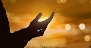 Religious upbringing link to better health and well-being in adulthood Silhouette of human hand with open palm praying to god at sunset background