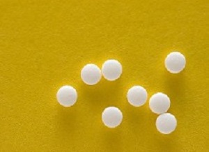 Saccharine tablets on a yellow background.