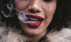 Woman smoking, close up on smoke and mouth