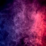 Colorful  purple and blue smoke clouds on dark background