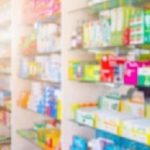 Medicines on pharmacy store shelves blurred background