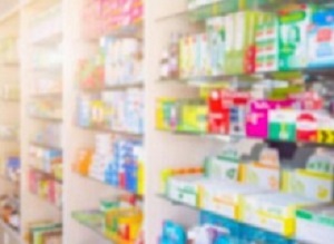 Medicines on pharmacy store shelves blurred background