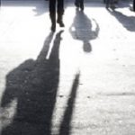 Blurry shadows of people oin the city sidewalk