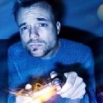 Man playing video games at night