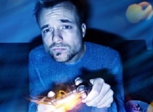 Man playing video games at night