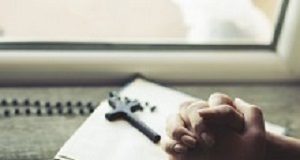 Jehovah's Witness parents may contest interim blood transfusion order woman hand cross on the book in window background