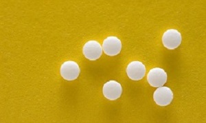 Saccharine tablets on a yellow background.