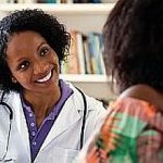 Laughing african american female doctor with patient