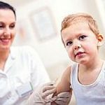 Pediatrician makes vaccination to small boy
