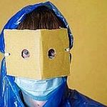 person in a home-made protective suit and medical mask in anxiety from a coronovirus pandemic