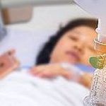 Medical drip with patient in the hospital blurred background
