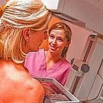 Nurse Assisting Patient Undergoing Mammogram
