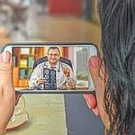 Woman contacts telemedicine doctor by mobile phone