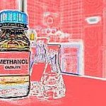 Selective focus of methanol brown amber glass bottle inside a laboratory. Blurred background with copy space.