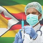 Doctor with syringe in hands and flag on background series – Zimbabwe