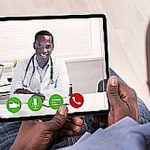African Person Sitting With Digital Tablet