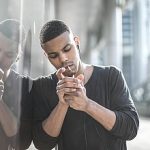 Handsome guy smoking a cigarette in the street