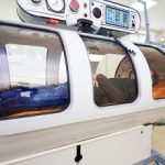 the guy in the black T-shirt lies in the hyperbaric chamber