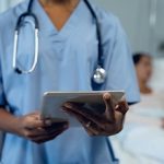 Female doctor using digital tablet in the ward at hospital