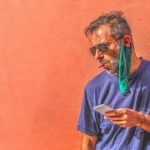 handsome mature man, tired of the heat, has taken off his protective mask