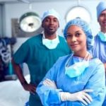 Portrait Of Multi-Cultural Surgical Team Standing In Hospital Operating Theater