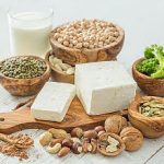 Selection vegan protein sources on wood background, copy space