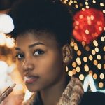 Vaping girl on night city street