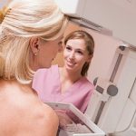 Nurse Assisting Patient Undergoing Mammogram
