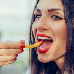 5-MB-Editors Picks-08-07-2021-Snack-Woman-Chips-Fries-iStock-685958688