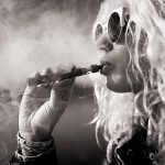 Black and white picture of woman smoking e-cigarette