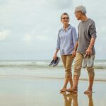 6-MB-Editors Picks-10-03-2022-Couple-Walk-Steps-Beach-iStock-1182878131