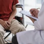 male patient sitting and consulting a doctor Prostate cancer problem Std Caucasian Man with his hand holding his crotch prostate inflammation erection problems