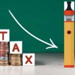 cubes with the word Tax on money pile of coins