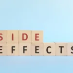 Side effects word on wooden blocks in blue background typography.